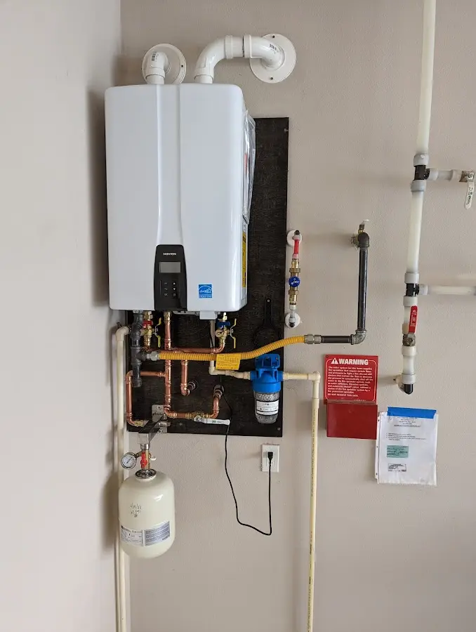 Professional plumber installing copper piping in a Millsboro home